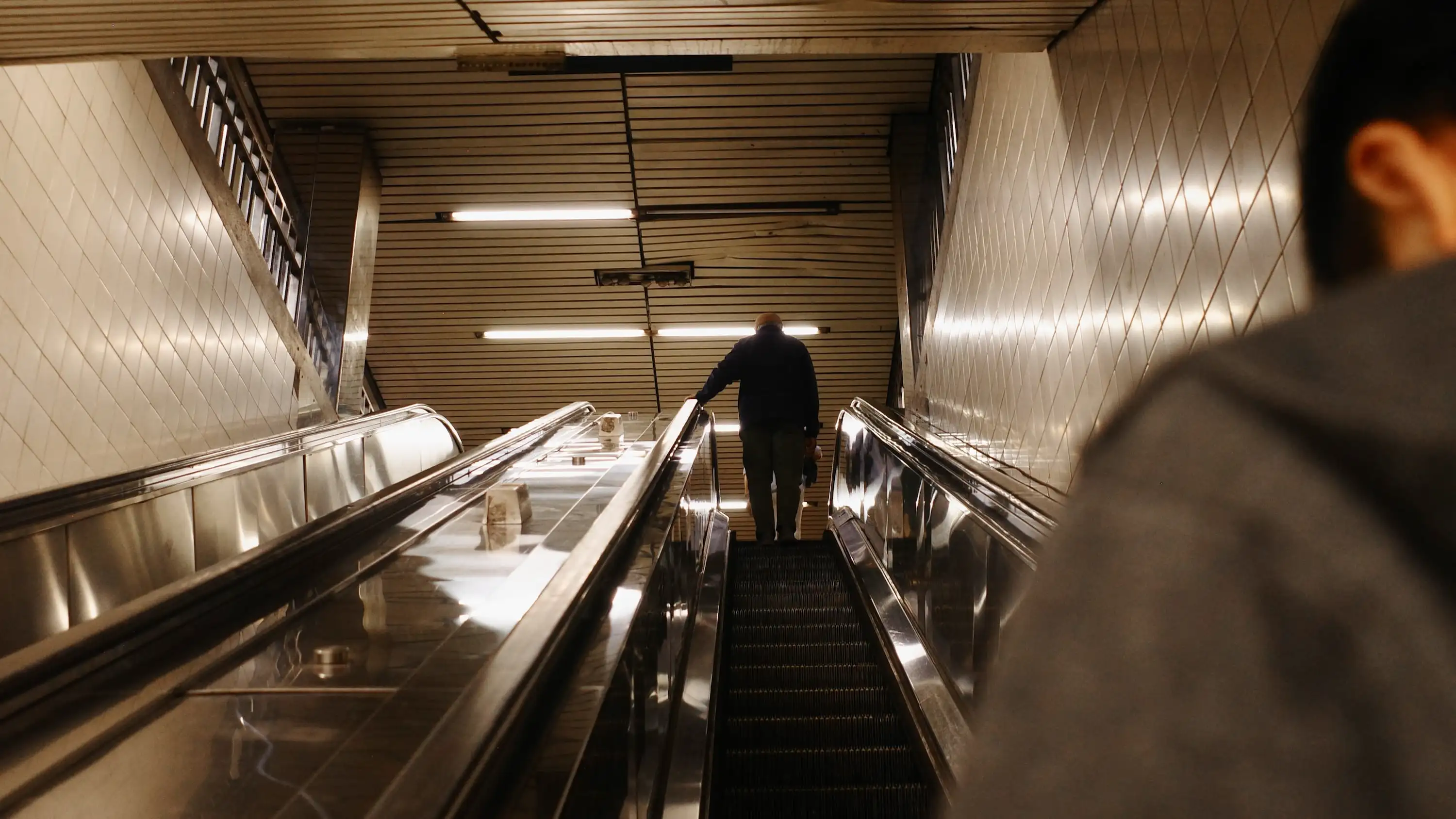 Riding an escalator out of a subway station